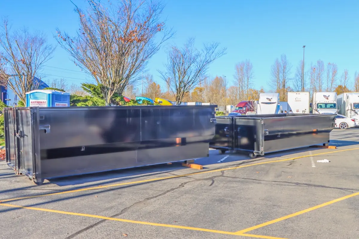 Professional dumpster rental service with roll-off container on residential driveway in Deming